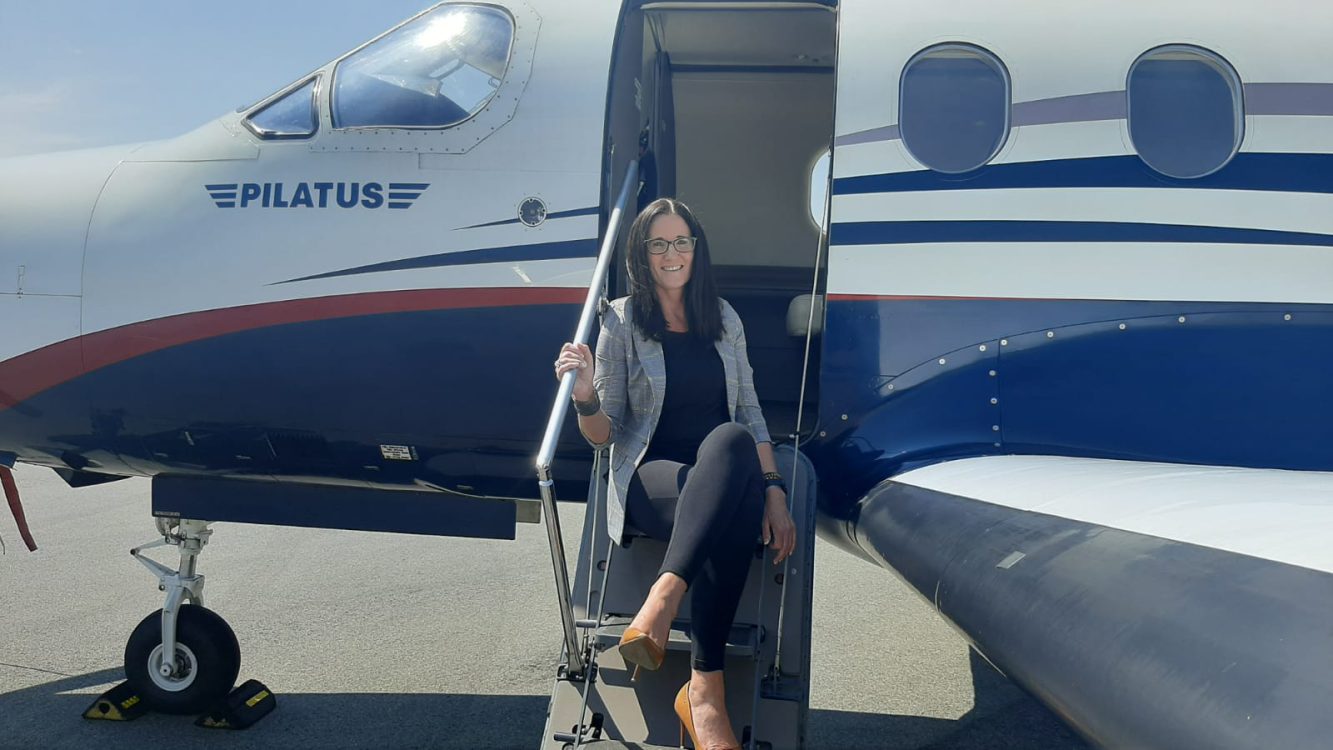 Jenny V on the steps of a private jet