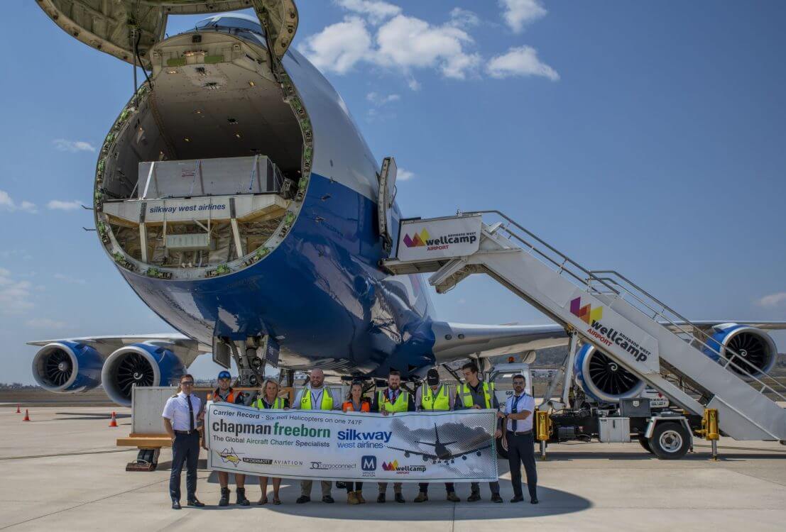 Chapman freeborn and silk way banner outside Cargo plane