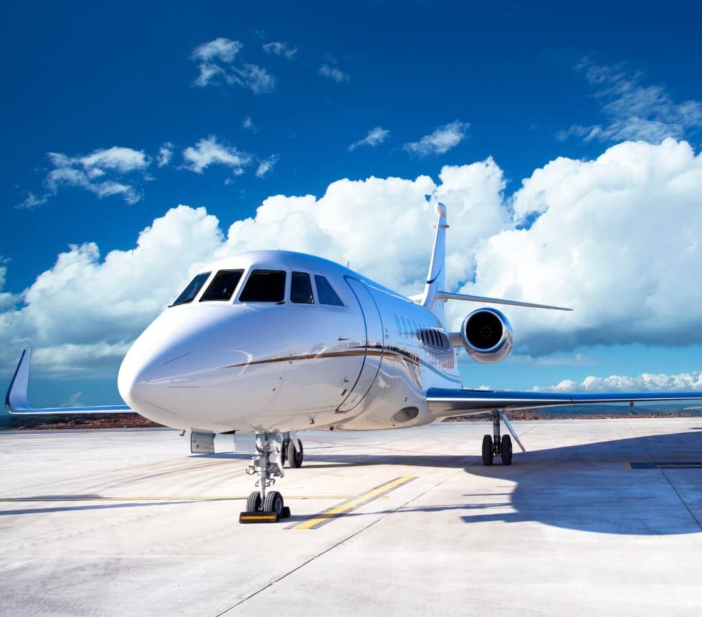 woman on a private jet checking her emails via onboard wifi