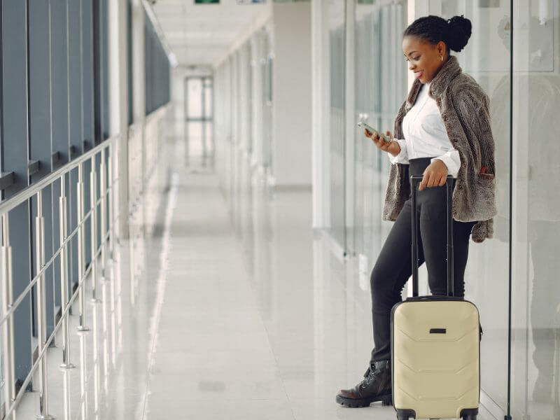 Young business woman using terminal at airport