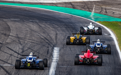 Multiple formula one cars racing around a track