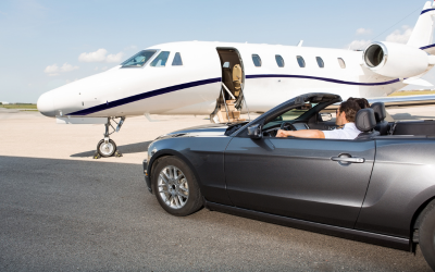 A car parked next to a private jet