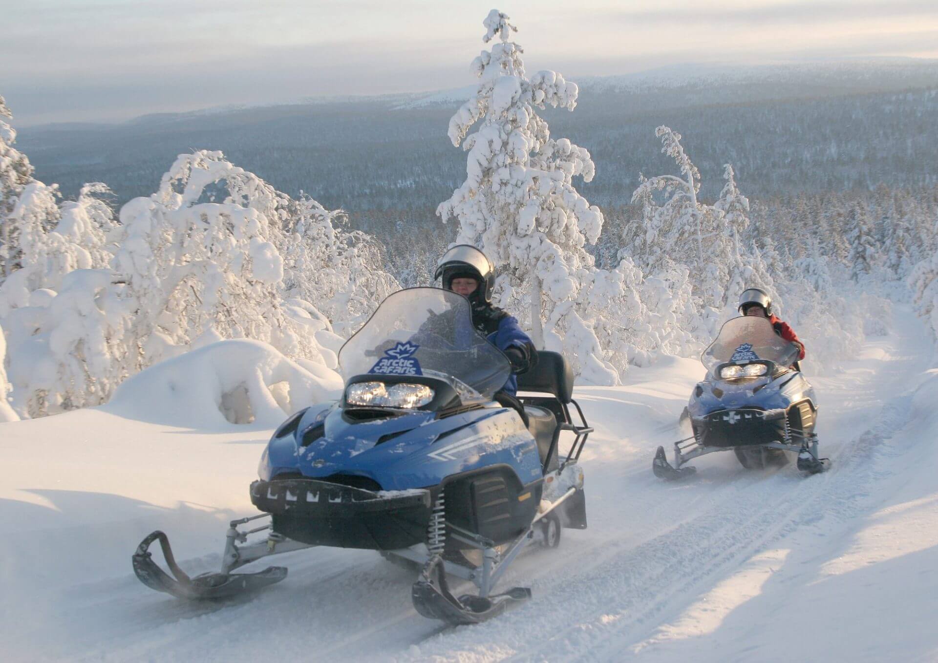 Snowmobiling through forest
