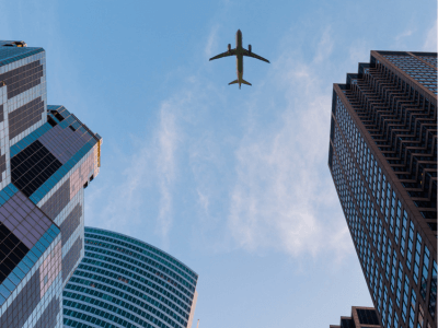 Plane flying out buildings